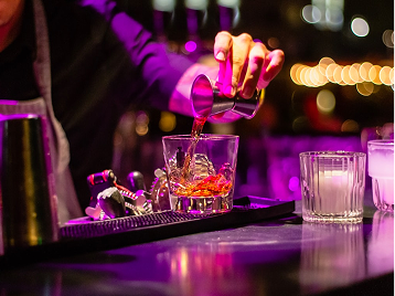 Bartender pouring a cocktail