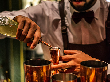 Bartender pouring drinks at a party